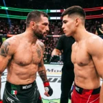 Brandon Moreno and Joseph Morales face off in the octagon during Noche UFC, illuminated with Mexican colors